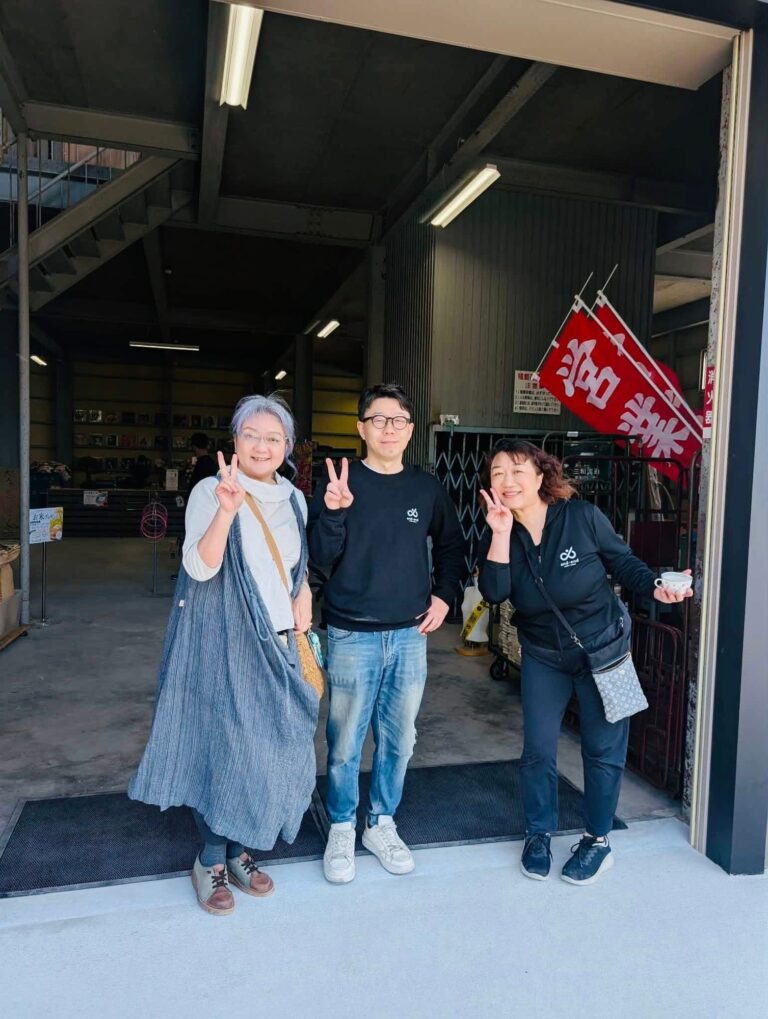 入口で笑顔を見せる三人。